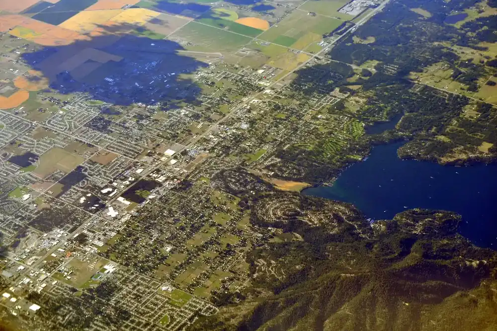 Aerial view of Hayden, Idaho, its neighborhoods, golf fairways and the shore of Hayden Lake